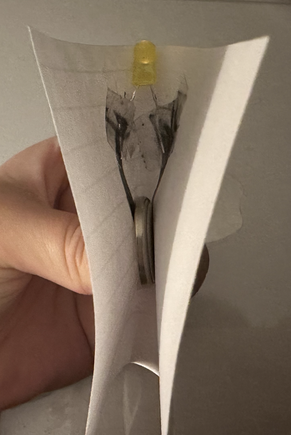 I tested it with a coin battery. The LED turned on but it was very dim, showing that graphite is not very conductive.