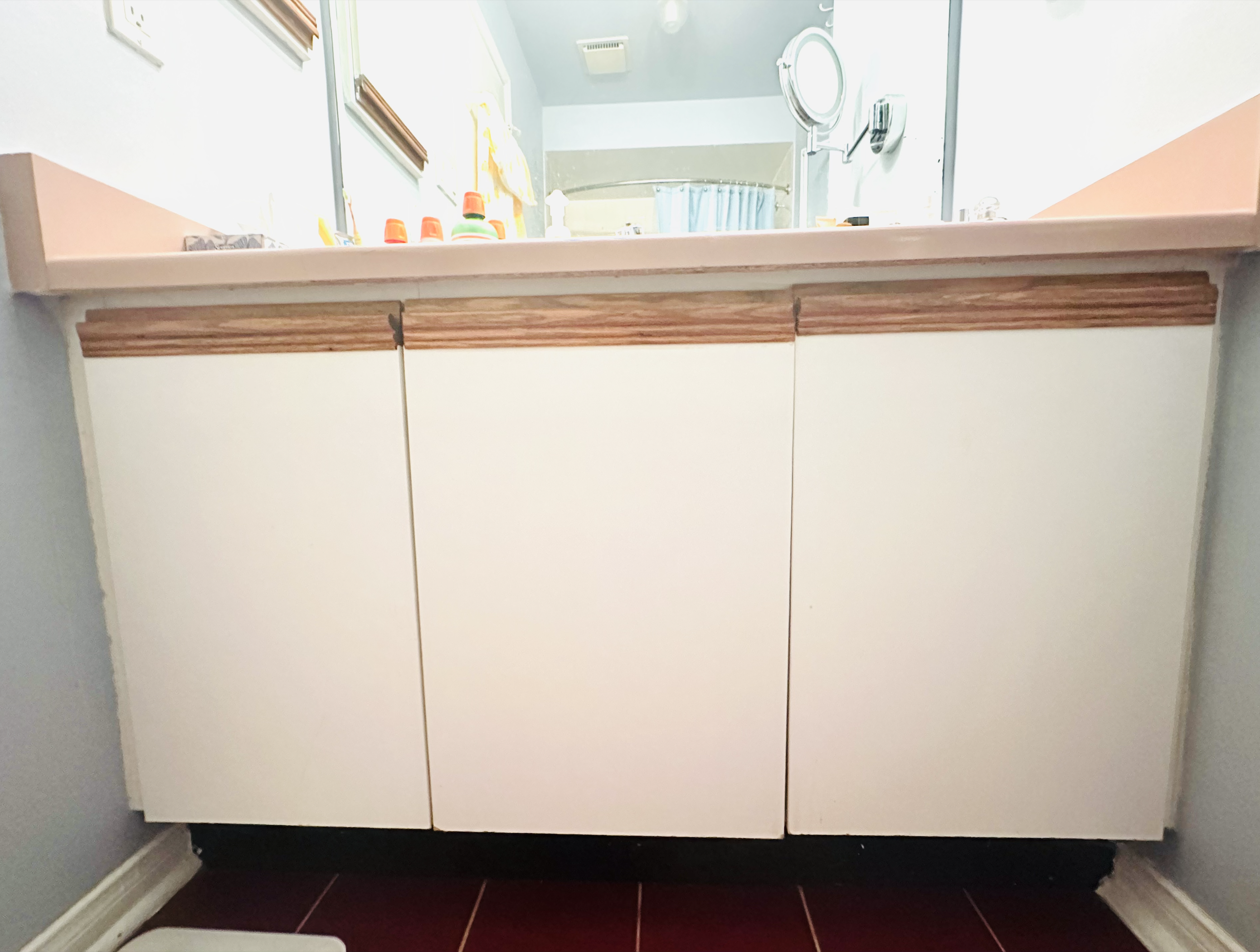 Close-up of the wooden cabinet under the bathroom sink